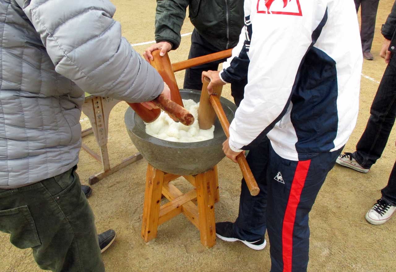 men making mochi in japan