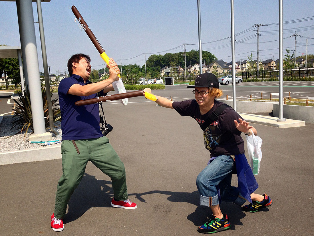 two people fighting with pocky poles
